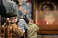 A young boy looks back during a Coptic church service in the St. ...