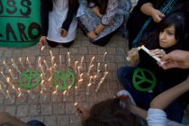 Pakistani youths light candle around peace signs during a ...