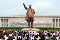 In this file photo, people stand in front of a giant statue of Kim Il ...