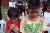 Children praying at an event in the Philippines