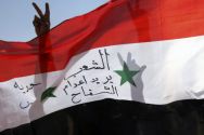Syrian expatriates gesture as they hold a Syrian national flag during ...