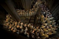 Catholic clergy walk holding candles during a procession inside the ...