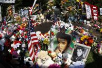 Flowers and tributes left by fans decorate Elvis Presley's grave at ...