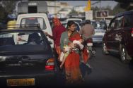 This 21 December photo shows an Indian woman carrying her baby as she ...