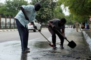 south-sudan-civilians-clean-the-streets-of-dried-blood-from-an-unidentified-soldier-who-was-killed-following-the-recent-fighting-outside-the-presidential-state-house-in-south-sudans-capital-jub