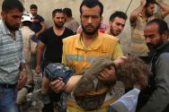 a-man-carries-a-child-after-an-airstrike-in-aleppo