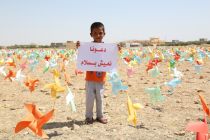 a-yazidi-child-holds-a-sign-which-reads-let-us-live-in-peace