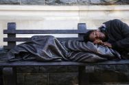 a-man-sleeps-on-the-sculpture-of-homeless-jesus-in-front-of-the-archdiocese-of-washington-catholic-charities-offices-in-washington