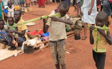 martin-andrea-10-and-a-friend-play-with-toy-guns-made-fromreeds-at-a-displaced-persons-camp-protected-by-un-peacekeepers-in-wau-south-sudan