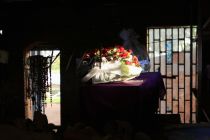 a-rose-bouquet-is-laid-on-a-coffin-in-the-catholic-church-in-nyamata-containing-the-remains-of-victims-of-mass-killings-during-the-1994-genocide