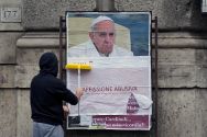 a-worker-covers-with-a-banner-reading-illegal-poster-a-poster-depicting-pope-francis-and-accusing-him-of-attacking-conservative-catholics