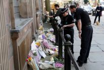 police-look-at-flowers-left-to-mark-victims-of-the-manchester-attack