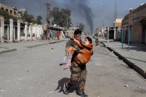 an-iraqi-special-forces-soldier-carries-a-woman-injured-during-a-battle-between-iraqi-forces-and-islamic-state