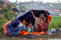 rohingya-refugees-shelter-from-the-rain-in-a-camp-in-coxs-bazar-bangladesh-september-17-2017