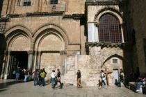 Tourists walk outside the Church of the Holy Sepulchre in the Old ...
