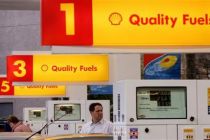 People fill their cars with fuel at a Shell garage in Glasgow, ...
