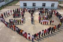 Pupils stand to form the shape of a heart and the date of the ...
